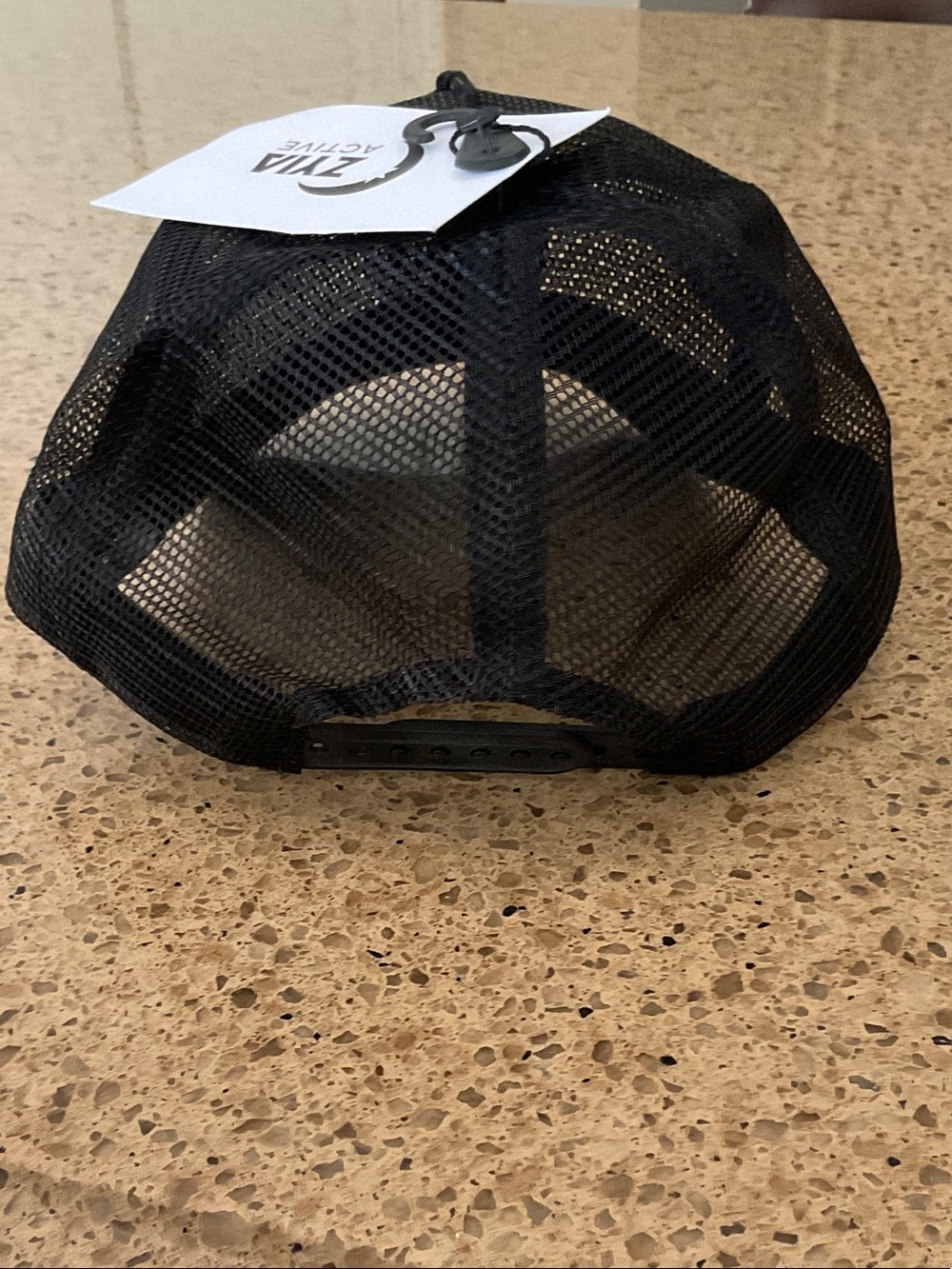 Black Mesh Trucker Hat with White Circular Logo Patch - Picture 2 of 3
